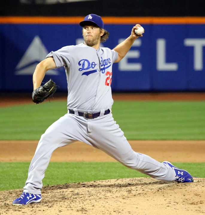Clayton Kershaw in the Dodgers' gray road uniform, mid-delivery on the mound